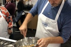 Whisking the vinaigrette.