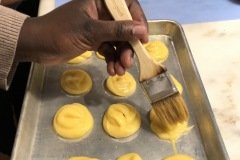 egg wash on the pate au choux for our profiteroles