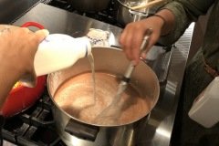 adding milk to chocolate pudding