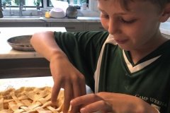 Fluting the edge of the peach pie