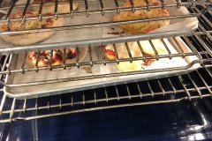 individual pizzas in the oven